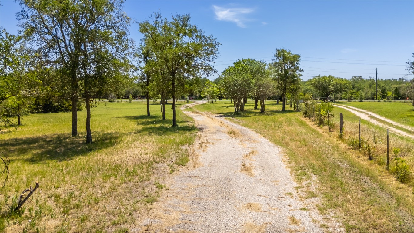 7502 Wells Trace Manor, TX 78653 - Photo 23 of 31 a view of a yard with swimming pool and trees