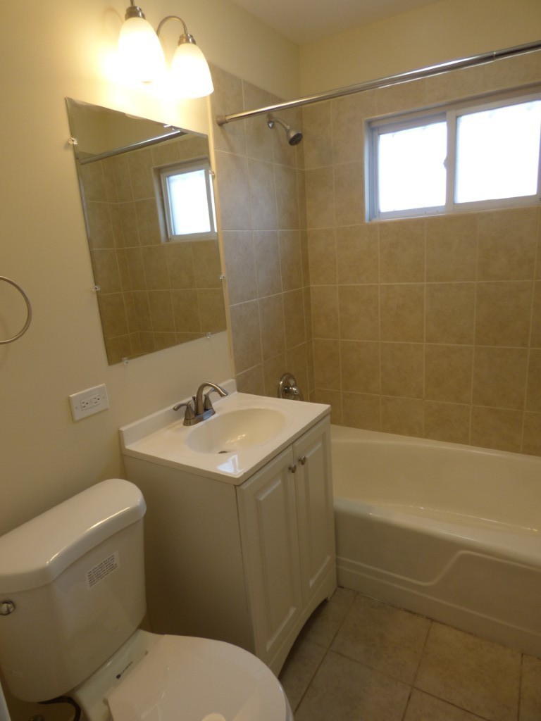 1626 West Estes Avenue, Unit 1F Chicago, IL 60626 - Photo 9 of 9 a bathroom with a sink toilet and shower