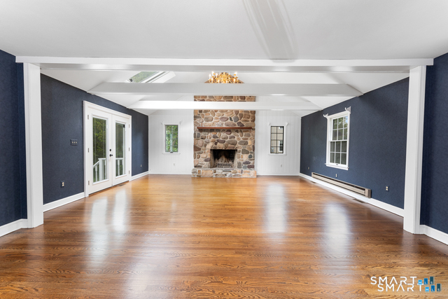 62 Chatham Road Berlin, CT 06037 - Photo 12 of 38 a view of an empty room with wooden floor fireplace and a window