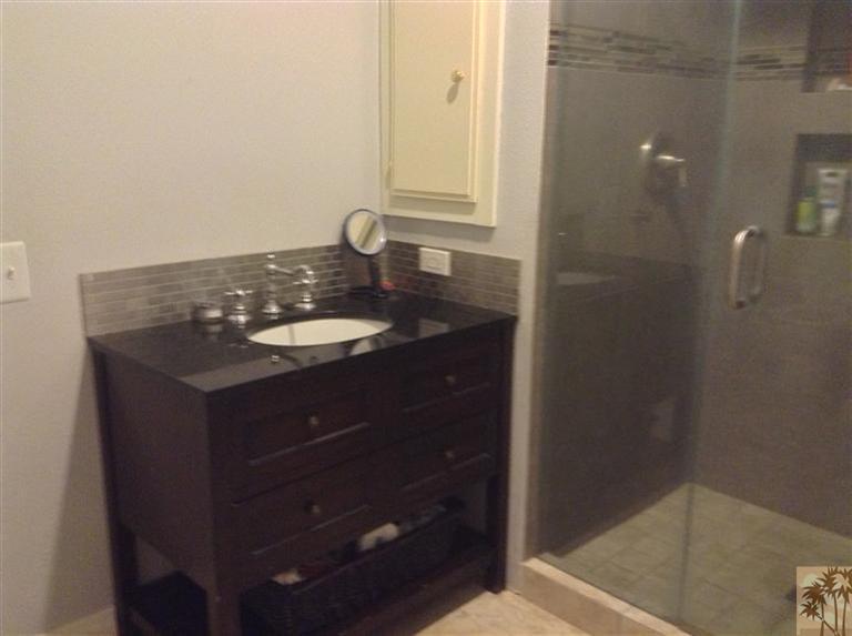 71862 Eleanora Lane Rancho Mirage, CA 92270 - Photo 2 of 3 a bathroom with a granite countertop sink a mirror and shower