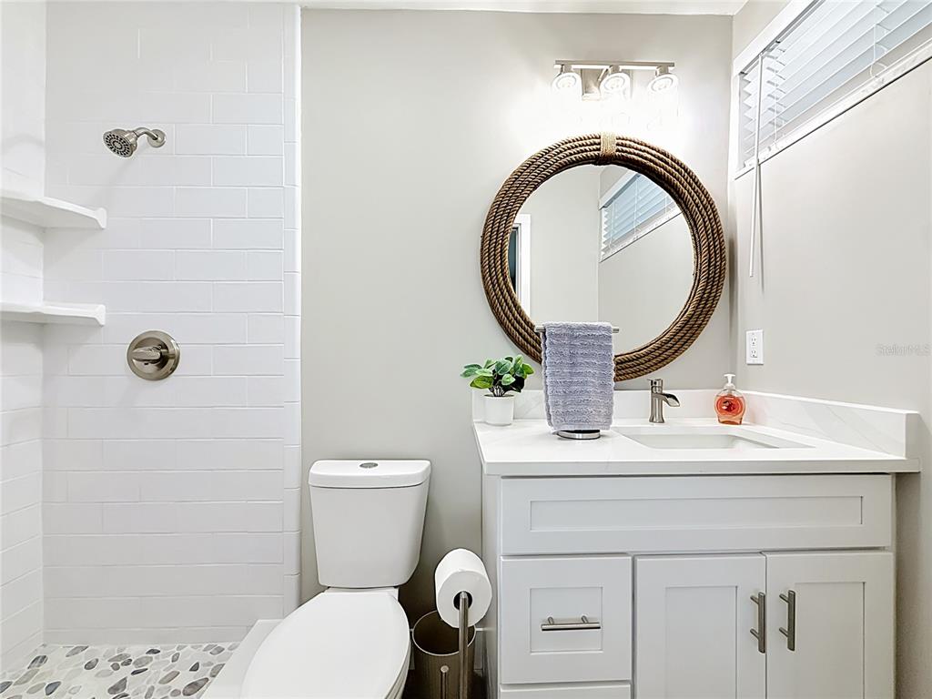 508 Shore Drive Largo, FL 33771 - Photo 15 of 31 a bathroom with a sink mirror vanity and toilet