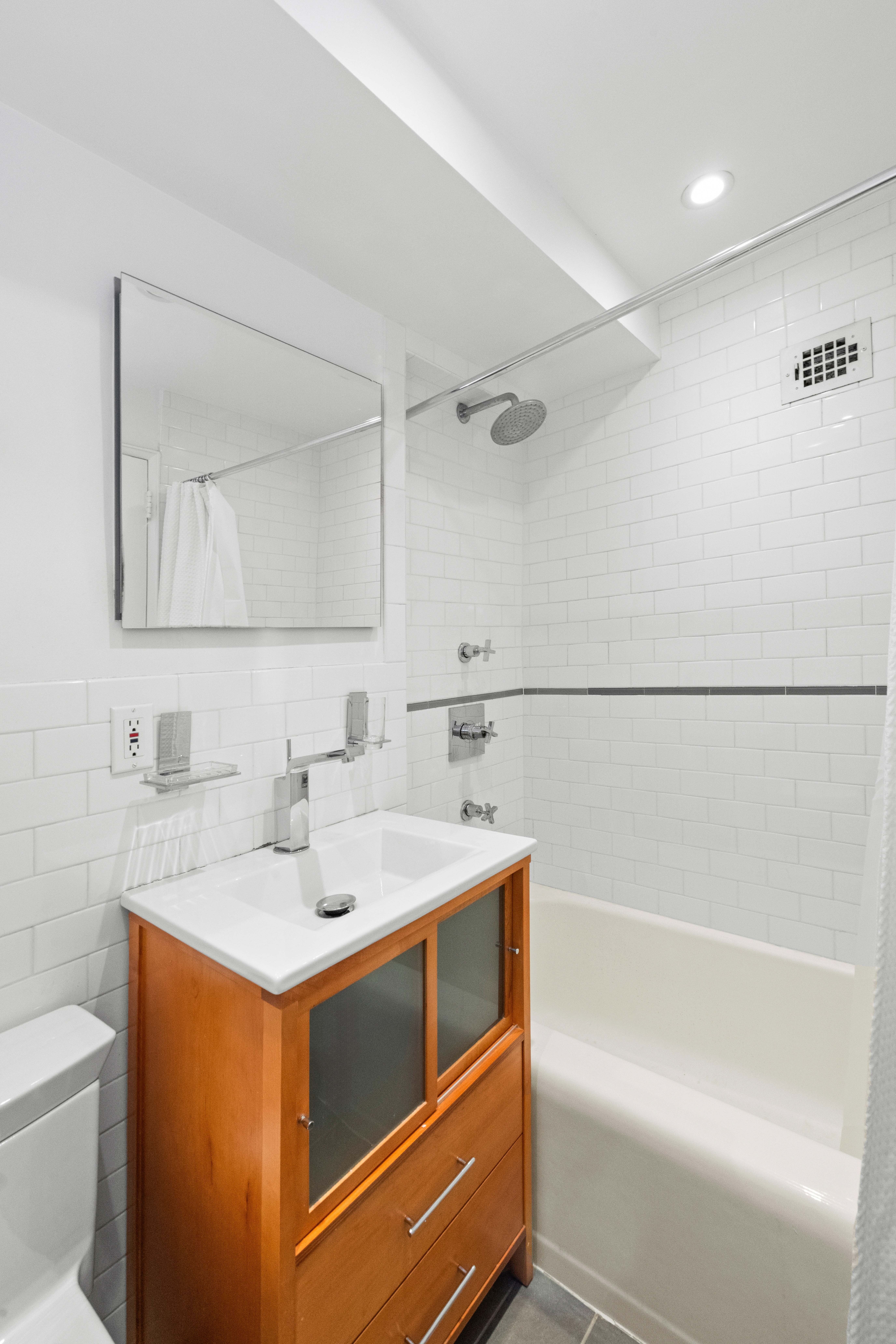 69 West 9th Street, Unit 8H Manhattan, NY 10011 - Photo 3 of 7 a bathroom with a sink and a mirror