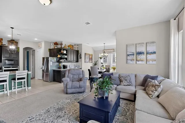 a living room with furniture fireplace and a window