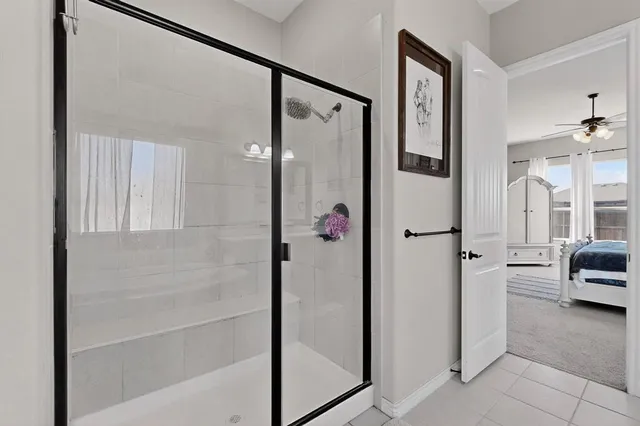 a bathroom with a tub shower and sink