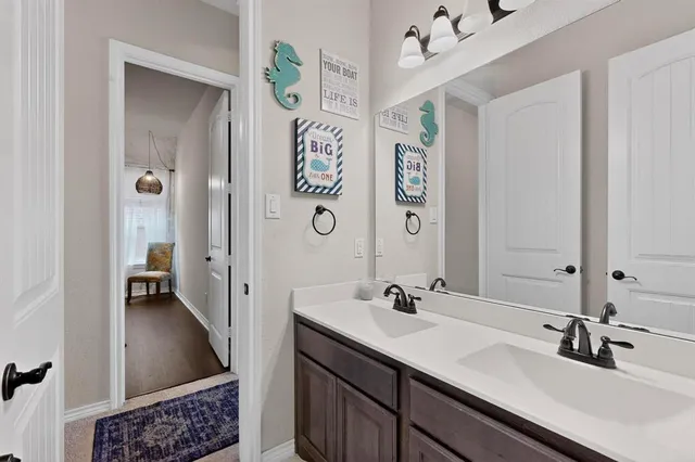 a bathroom with a double vanity sink a mirror and a shower