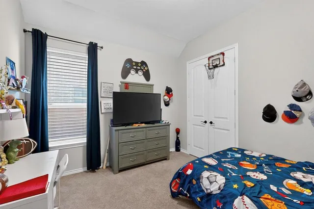 a bedroom with a bed and flat screen tv