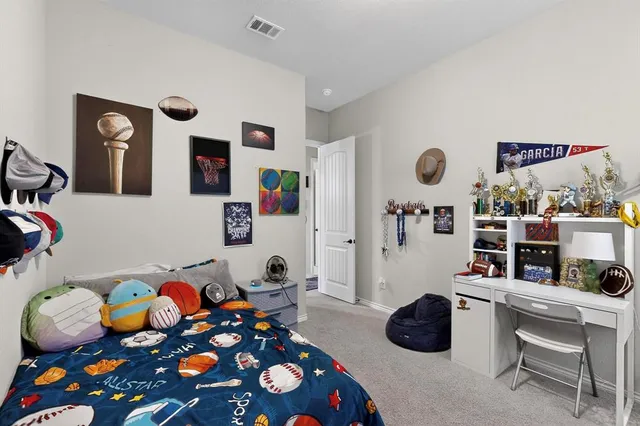 a bedroom with furniture and a book shelf
