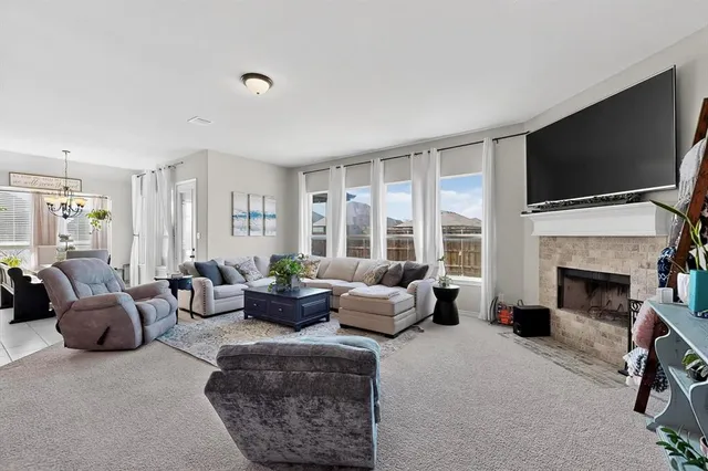 a living room with fireplace furniture and a flat screen tv