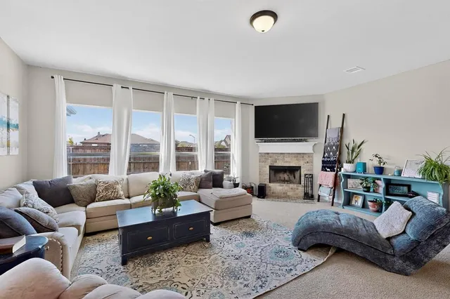 a living room with furniture a fireplace and a flat screen tv