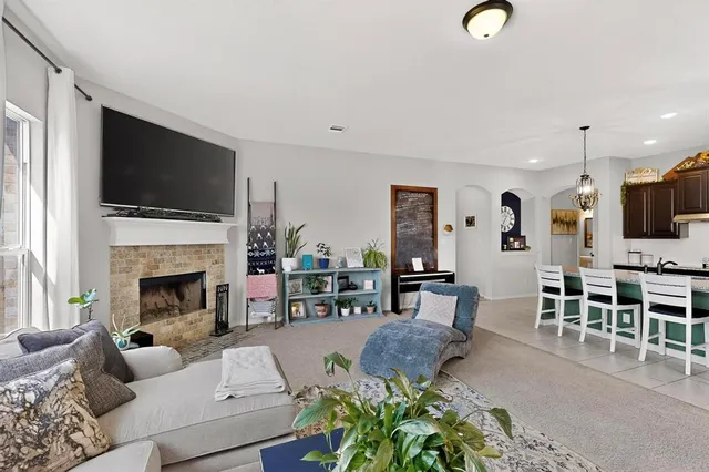 a living room with furniture fireplace and flat screen tv