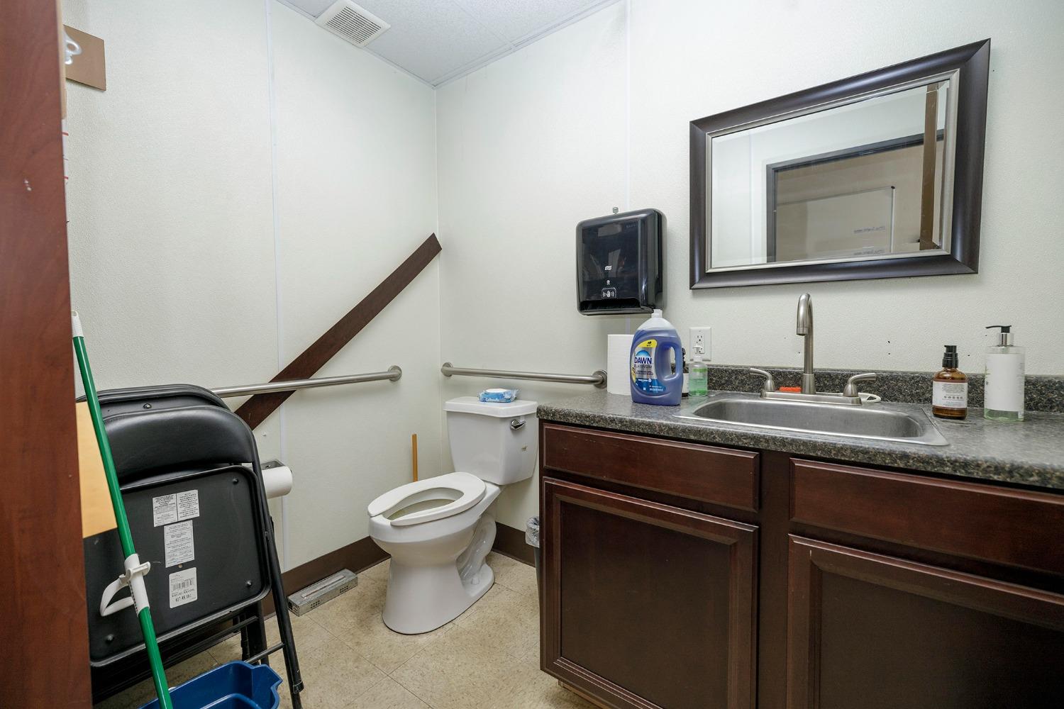 7831 Crows Landing Road Ceres, CA 95307 - Photo 15 of 23 a bathroom with a toilet sink and mirror