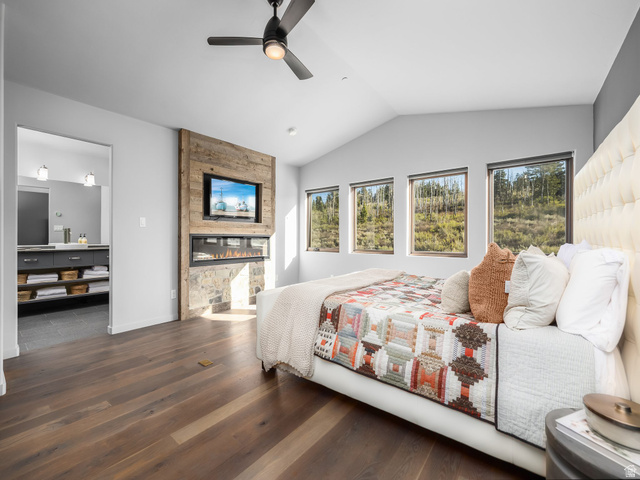 22677 East Snowbird Drive, Unit 47 Helper, UT 84526 - Photo 19 of 43 Bedroom featuring multiple windows, dark wood-style floors, a large fireplace, vaulted ceiling, and a ceiling fan