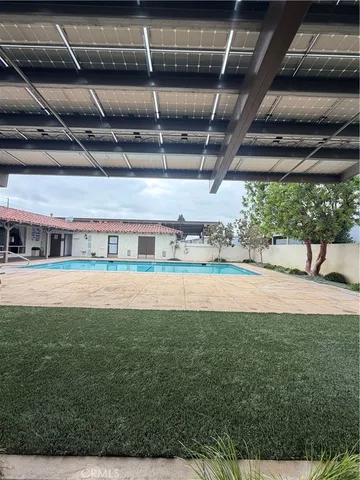 a view of pool with a yard