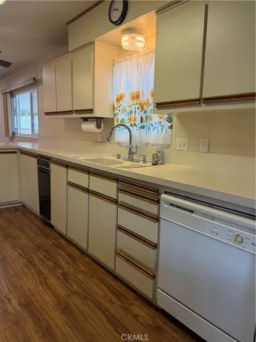 a kitchen with sink and cabinets