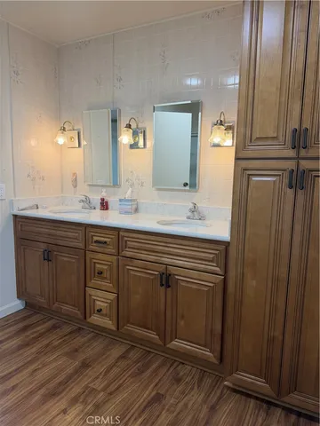 a spacious bathroom with a double vanity sink and a mirror