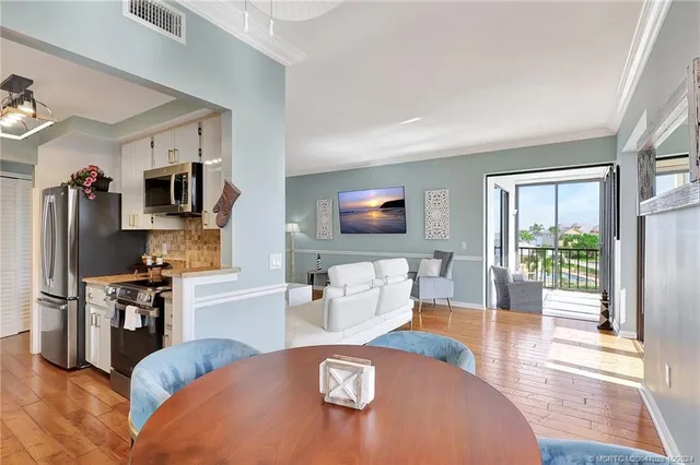 a kitchen with stainless steel appliances granite countertop a stove a microwave and a refrigerator