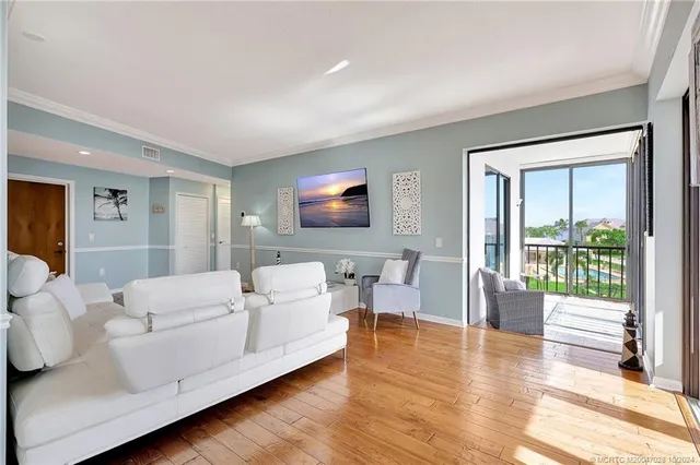 a view of a dining room with furniture a chandelier and wooden floor
