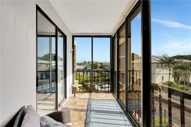 a bedroom with a bed a chandelier and a window