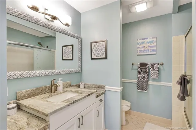 a bathroom with a granite countertop sink mirror and double