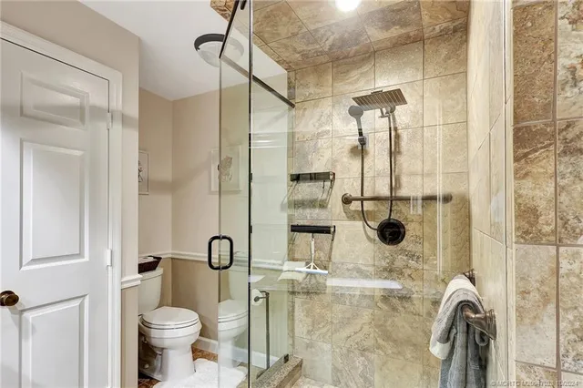 an aerial view of a house with a garden and lake view