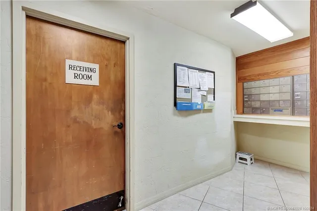 a view of a room with wooden floor and a lake view
