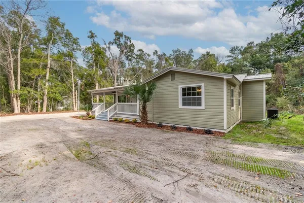 a view of a house with a backyard