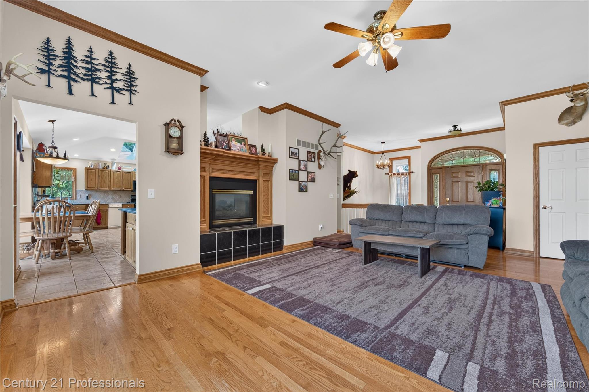 5675 36 Mile Road Romeo, MI 48065 - Photo 18 of 54 Wonderful view from the bay window, gorgeous hardwood floor, a 2 way fireplace (shared with kitchen) with a beautiful wood mantel and black tile surround, NOTE! a ceiling fan, and crown molding.