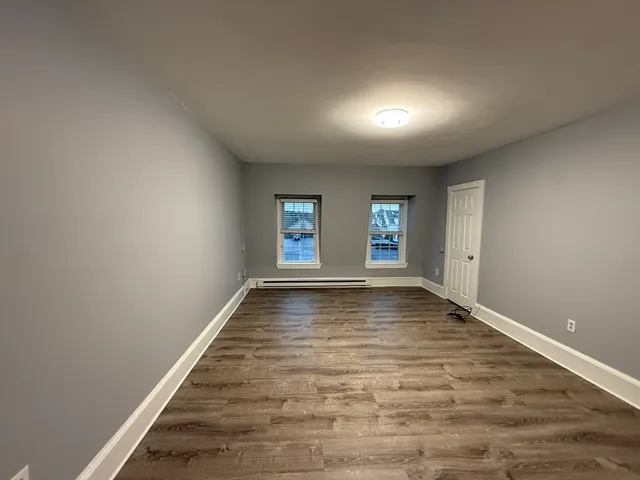 wooden floor in an empty room with window