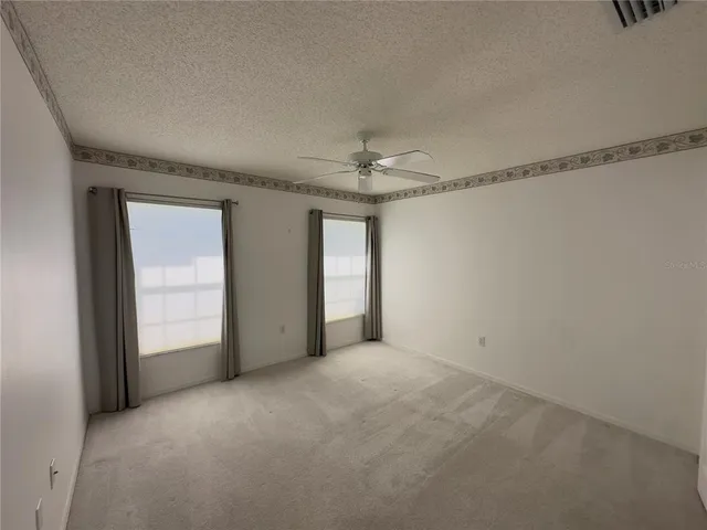 a view of a livingroom with a ceiling fan and window