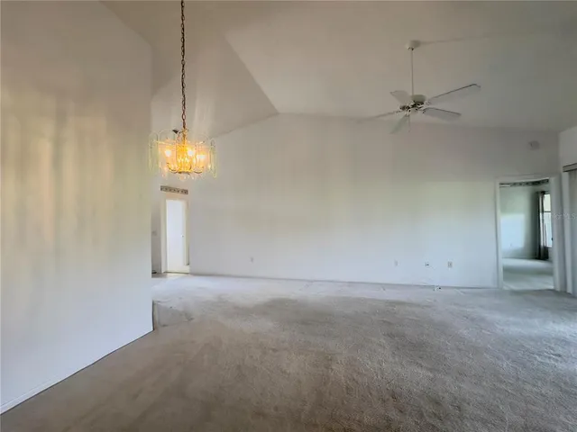 an empty room with a empty space and a ceiling fan