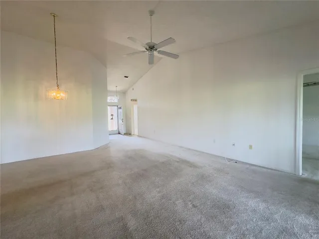 a view of an empty room with a ceiling fan