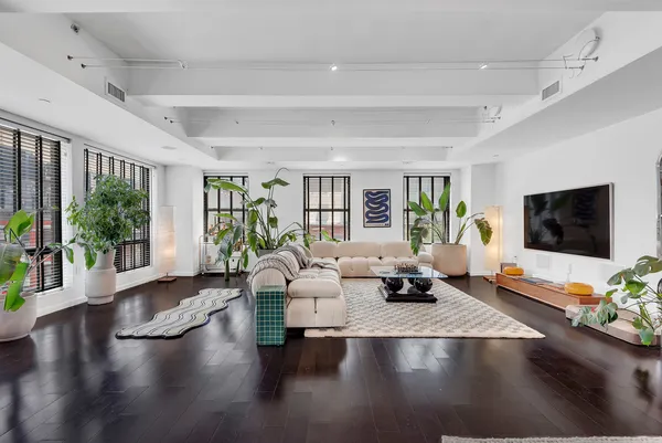 a bedroom with furniture and a large window