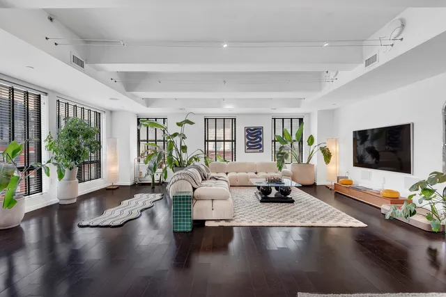a bedroom with furniture and a large window