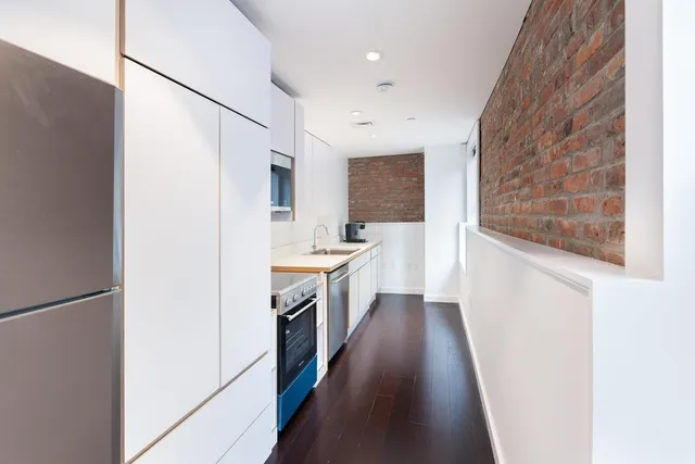 a living room with furniture fireplace and a large window