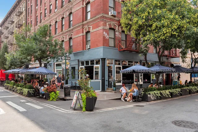 a living room with furniture and a book shelf