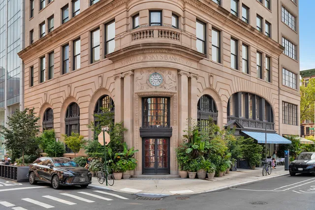 a bedroom with a large bed couch and a window