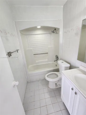 a bathroom with a toilet a sink and bathtub