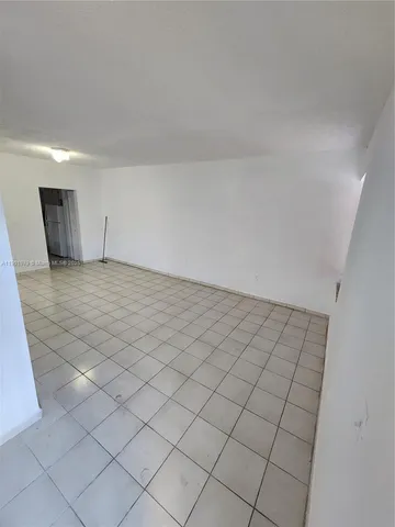 a view of an empty room and wooden floor