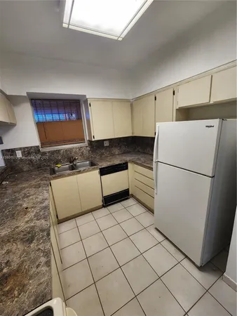 a kitchen with stainless steel appliances granite countertop a refrigerator sink and cabinets