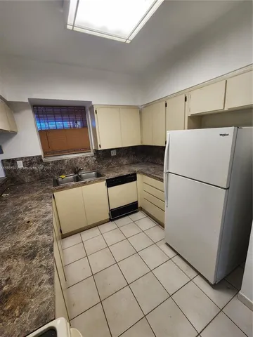 a kitchen with stainless steel appliances granite countertop a refrigerator sink and cabinets