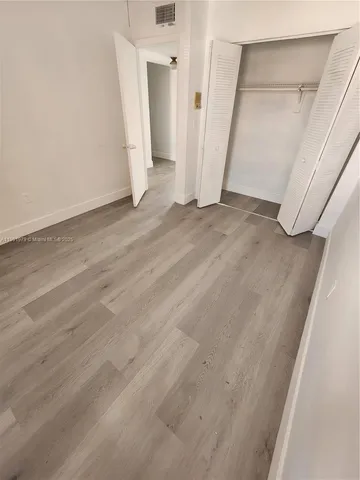 an empty room with an entrance to other room