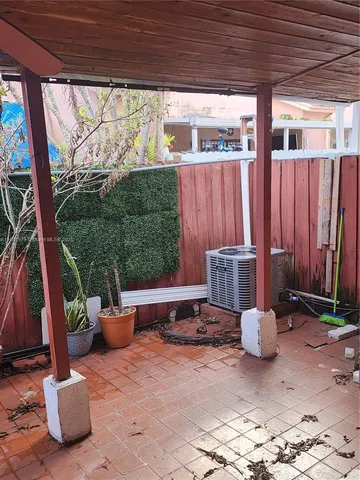 a view of a patio with chairs and plants
