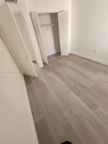 an empty room with an entrance to other room