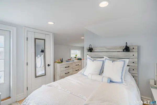 a large white bed in a white room