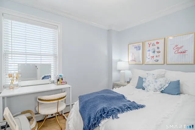 a bedroom with a bed and a chair