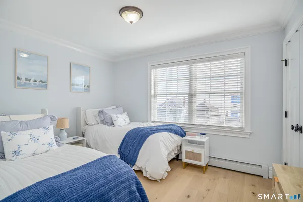 a bedroom with two beds and a window