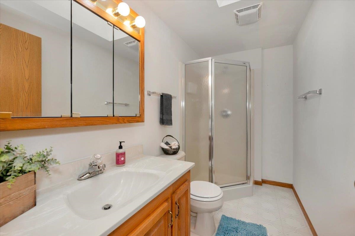 6373 Maple Grove Road Cloquet, MN 55720 - Photo 13 of 42 Full bathroom featuring a stall shower and vanity