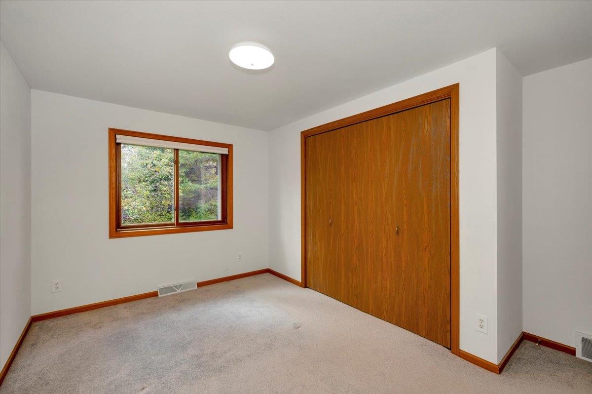 6373 Maple Grove Road Cloquet, MN 55720 - Photo 14 of 42 Unfurnished bedroom featuring carpet flooring and a closet