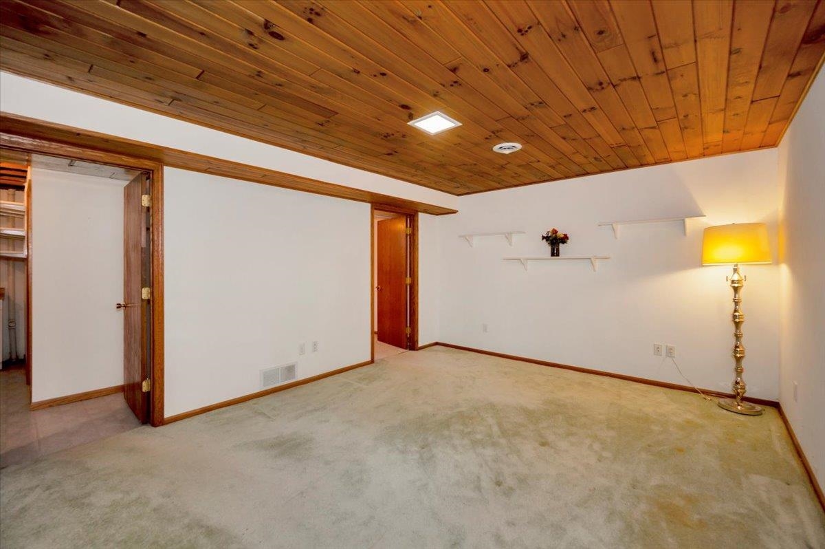 6373 Maple Grove Road Cloquet, MN 55720 - Photo 18 of 42 Finished basement featuring carpet and wooden ceiling