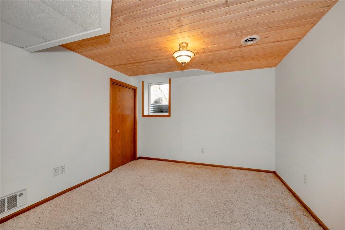 6373 Maple Grove Road Cloquet, MN 55720 - Photo 20 of 42 Carpeted spare room with wooden ceiling and baseboards